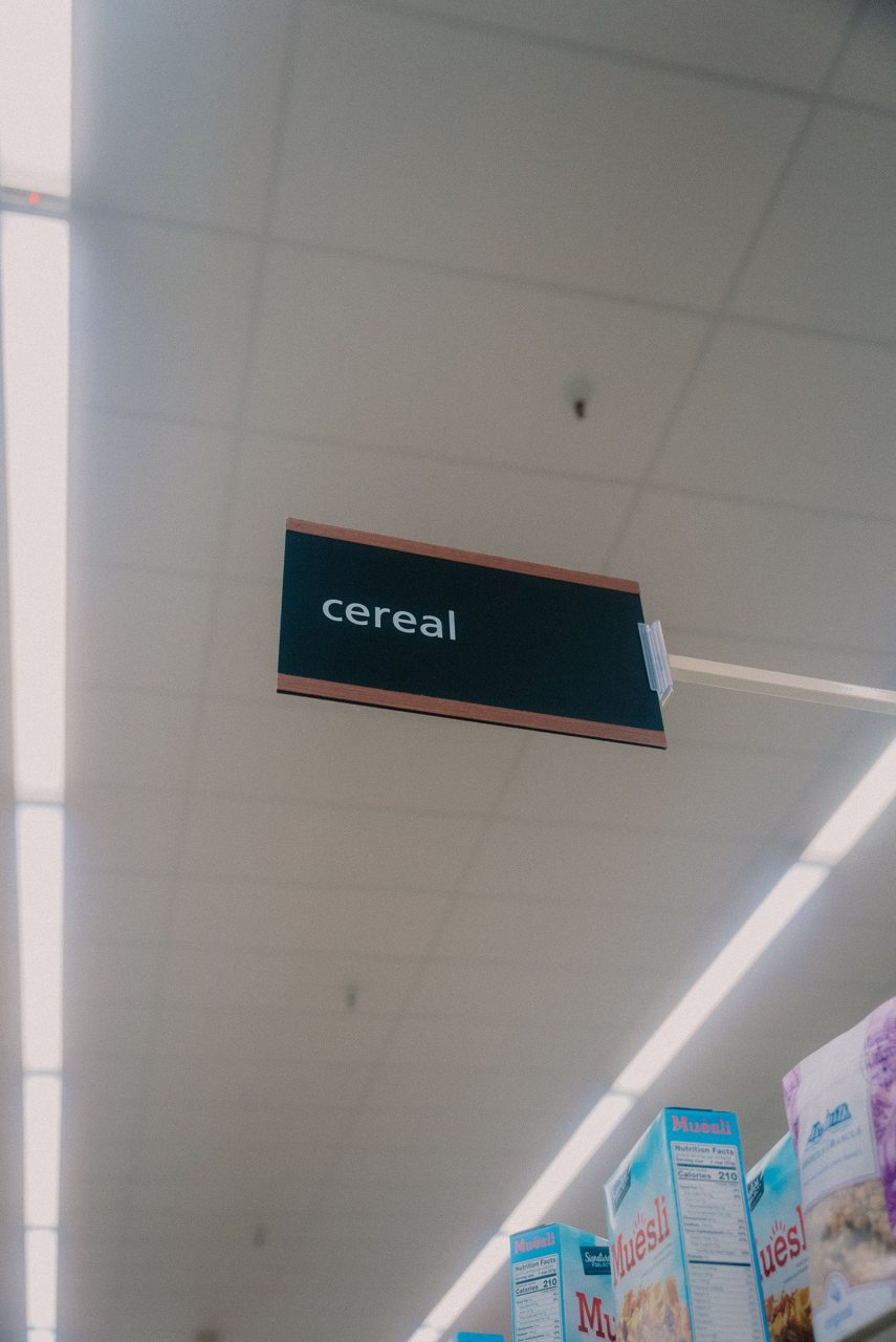 Free Low angle view of a supermarket cereal aisle, highlighting a prominent sign. Stock Photo
