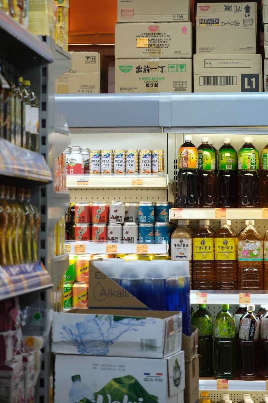 Free Bottles and cartons of drinks on supermarket shelves offering a diverse selection. Stock Photo